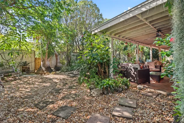 a view of a patio with table and chairs under an umbrella