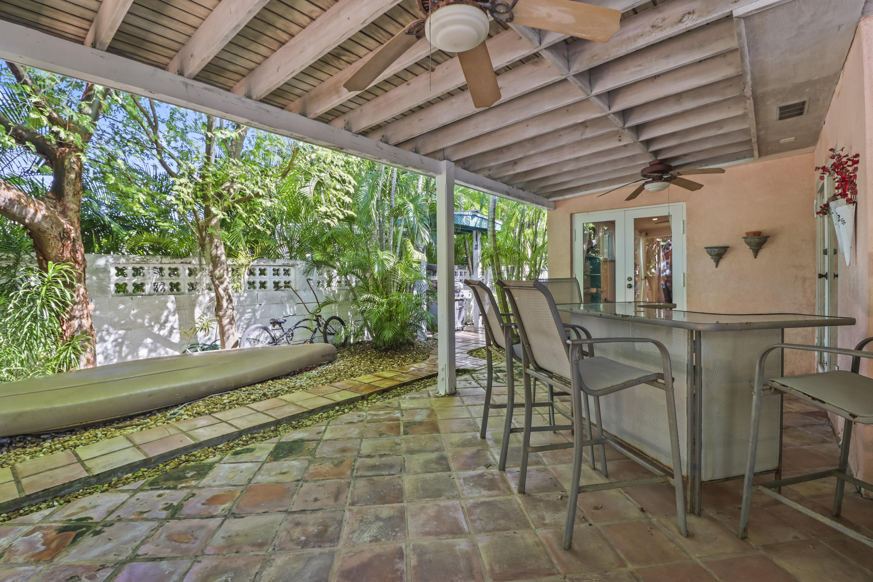 1406 Sunset Drive Key West, FL 33040 - Photo 23 of 23 a view of a patio with table and chairs and potted plants