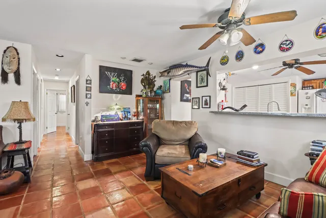 a living room with stainless steel appliances kitchen island granite countertop furniture and a dining table