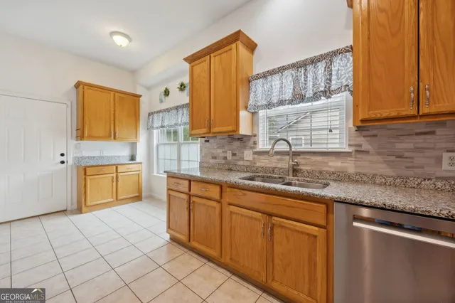 a kitchen with stainless steel appliances granite countertop a sink and a stove