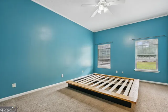 a bedroom with window and ceiling fan