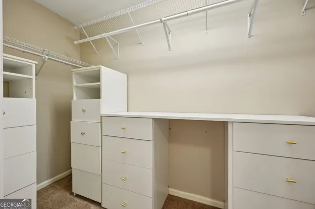 a view of walk in closet with empty racks