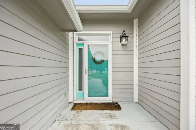 a view of a door and a window