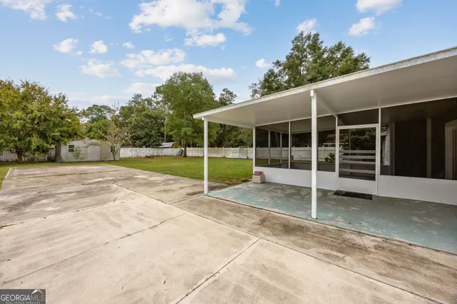 a view of an house with backyard and porch