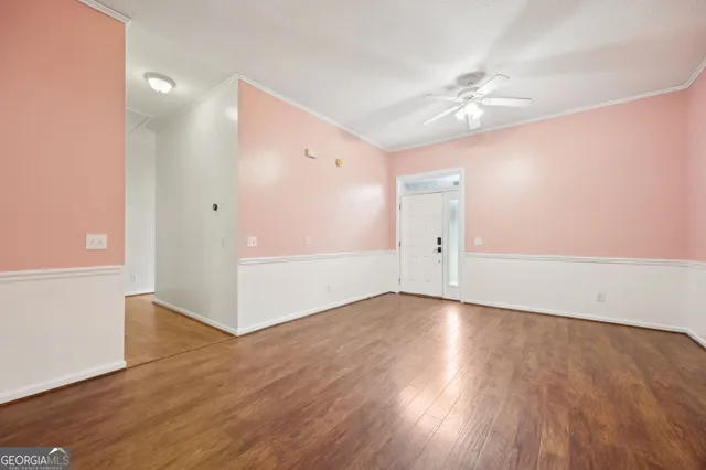 a view of an empty room with wooden floor