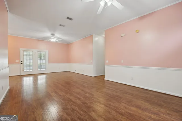 wooden floor in an empty room with a window