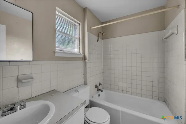 a bathroom with a sink toilet and bathtub