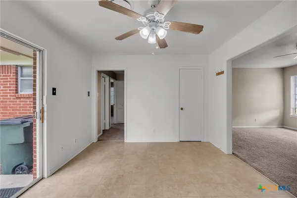 a view of a livingroom with a ceiling fan and window