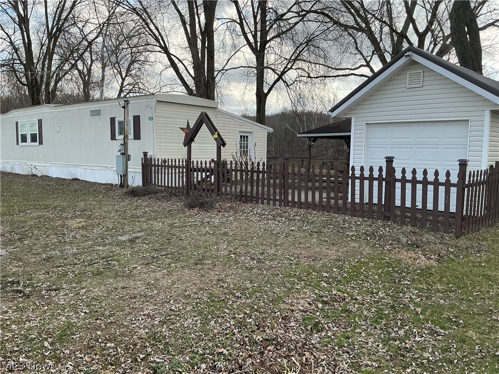 9385 North River Road East, Unit 33 Dresden, OH 43821 - Photo 2 of 19 View of side of property with an outdoor structure and a detached garage