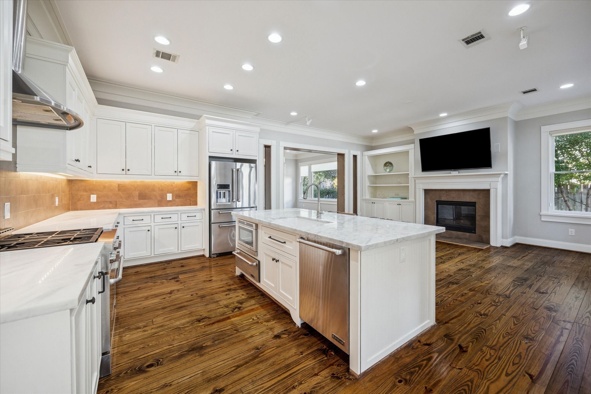 1226 Heights Boulevard Houston, TX 77008 - Photo 13 of 40 Expanded view highlights the kitchen’s layout, lighting, and high-end finishes. Open flow makes this space ideal for daily living and entertaining.