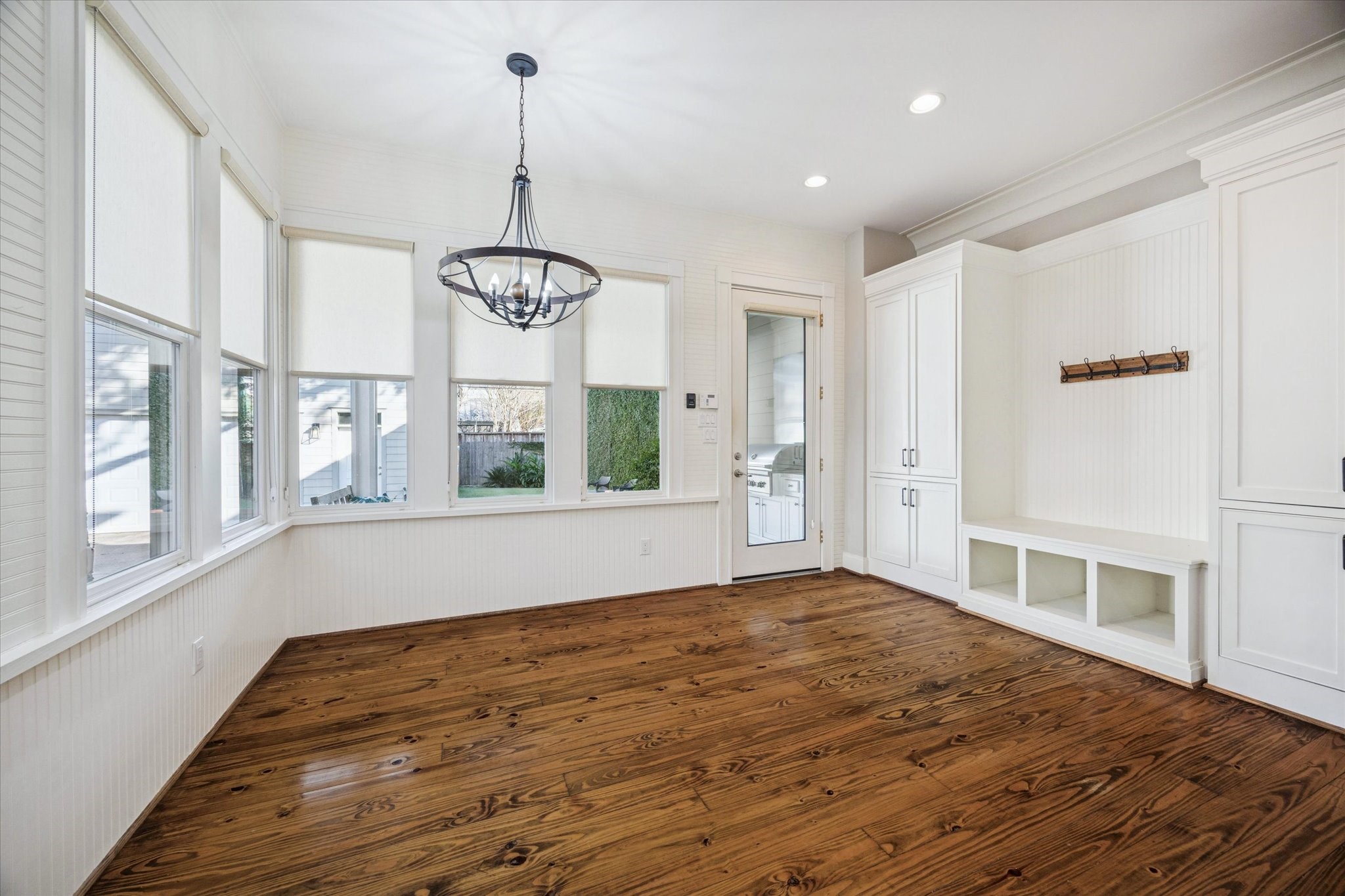 1226 Heights Boulevard Houston, TX 77008 - Photo 14 of 40 Charming breakfast area features built-in cabinetry, beadboard accents, and large windows overlooking the yard. A stylish light fixture adds character and warmth to the space.