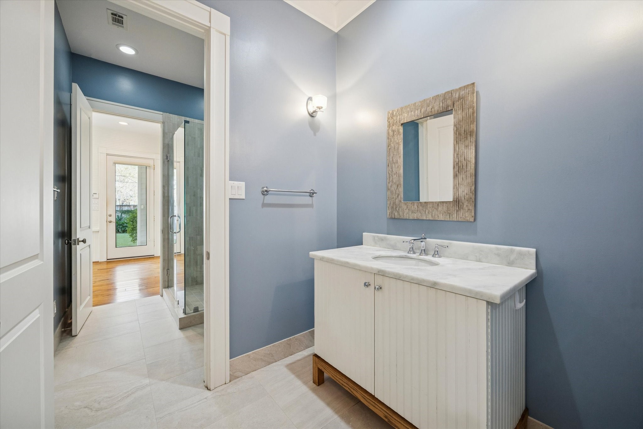 1226 Heights Boulevard Houston, TX 77008 - Photo 17 of 40 Bathroom features a marble-topped vanity with storage and updated lighting. Clean finishes and thoughtful design add comfort and functionality.