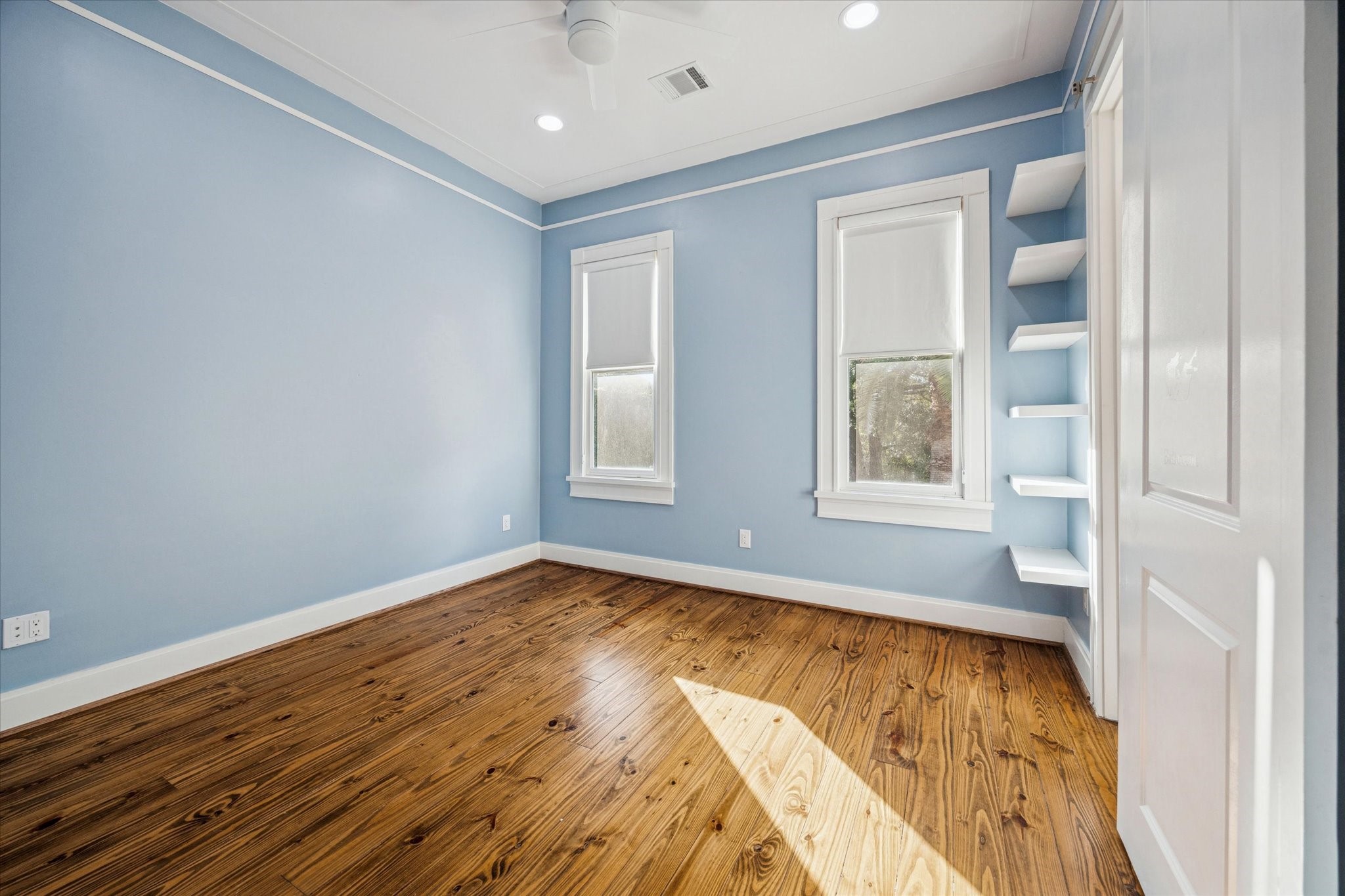 1226 Heights Boulevard Houston, TX 77008 - Photo 18 of 40 Bright bedroom showcases hardwood floors, custom shelving, and ample natural light. A perfect space for a bedroom, office, or flex room.