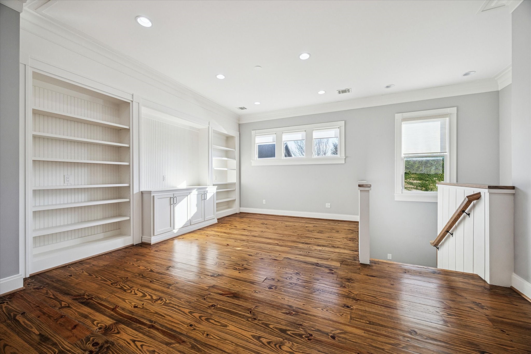 1226 Heights Boulevard Houston, TX 77008 - Photo 22 of 40 Large open landing room offers built-in shelving and abundant natural light. Ideal for a media room, home office, or additional living area.