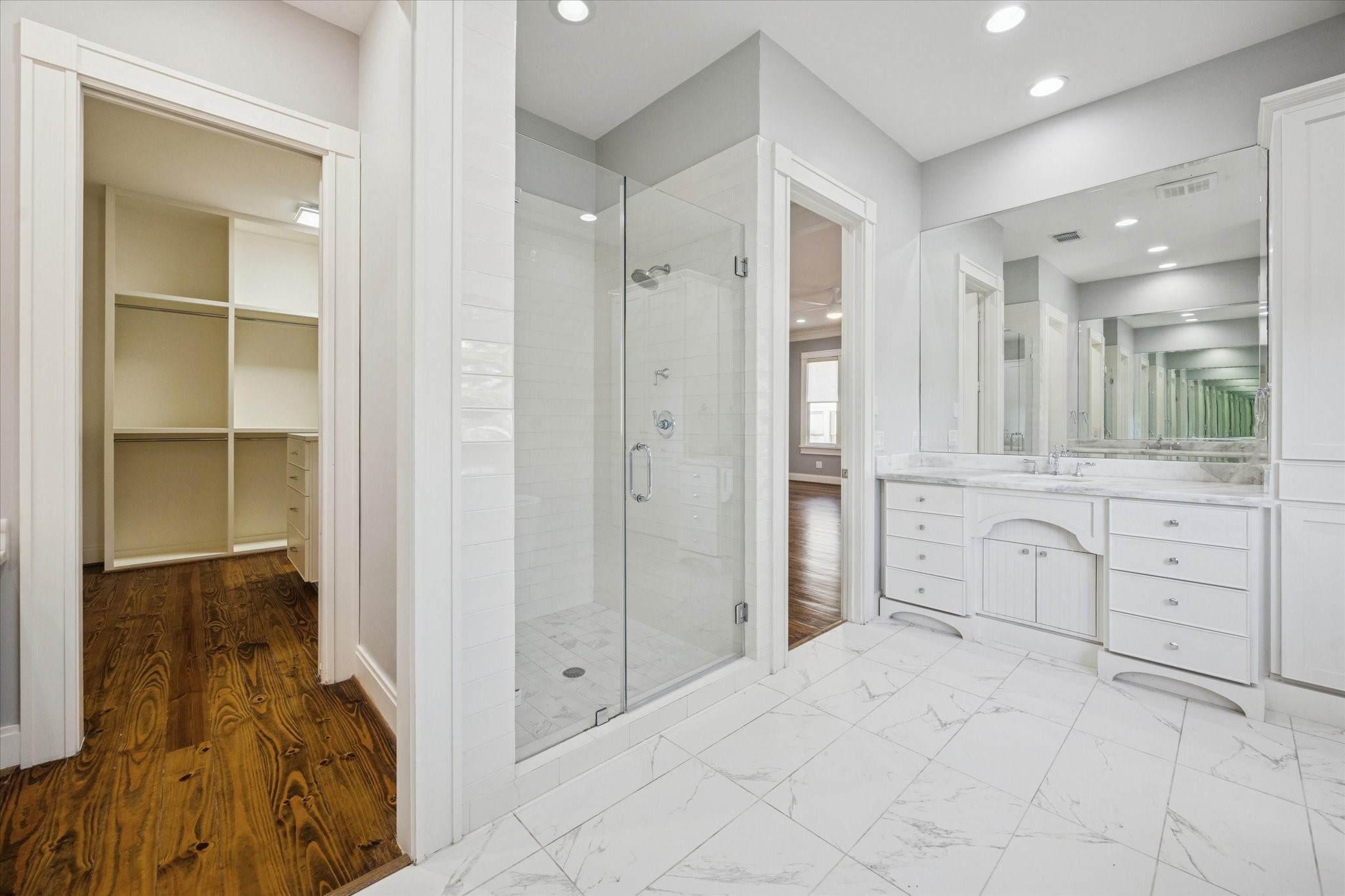 1226 Heights Boulevard Houston, TX 77008 - Photo 25 of 40 Another view highlights the walk-in glass-enclosed shower and dual vanity with extensive storage. Clean lines and soft tones give the space a modern, timeless look.