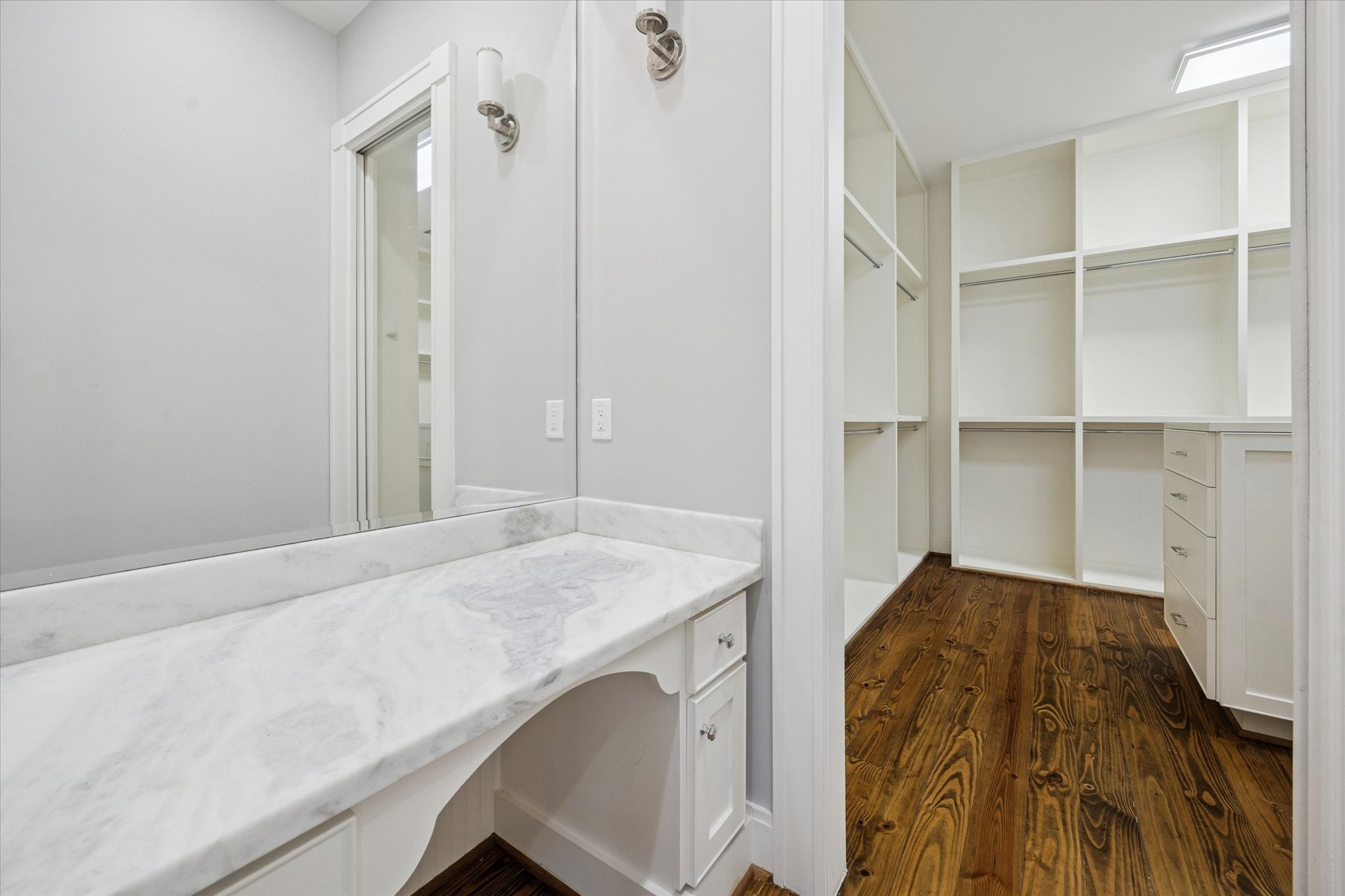 1226 Heights Boulevard Houston, TX 77008 - Photo 26 of 40 Custom walk-in closet offers built-in shelving, drawers, and hanging space. An adjacent vanity area adds convenience and functionality.
