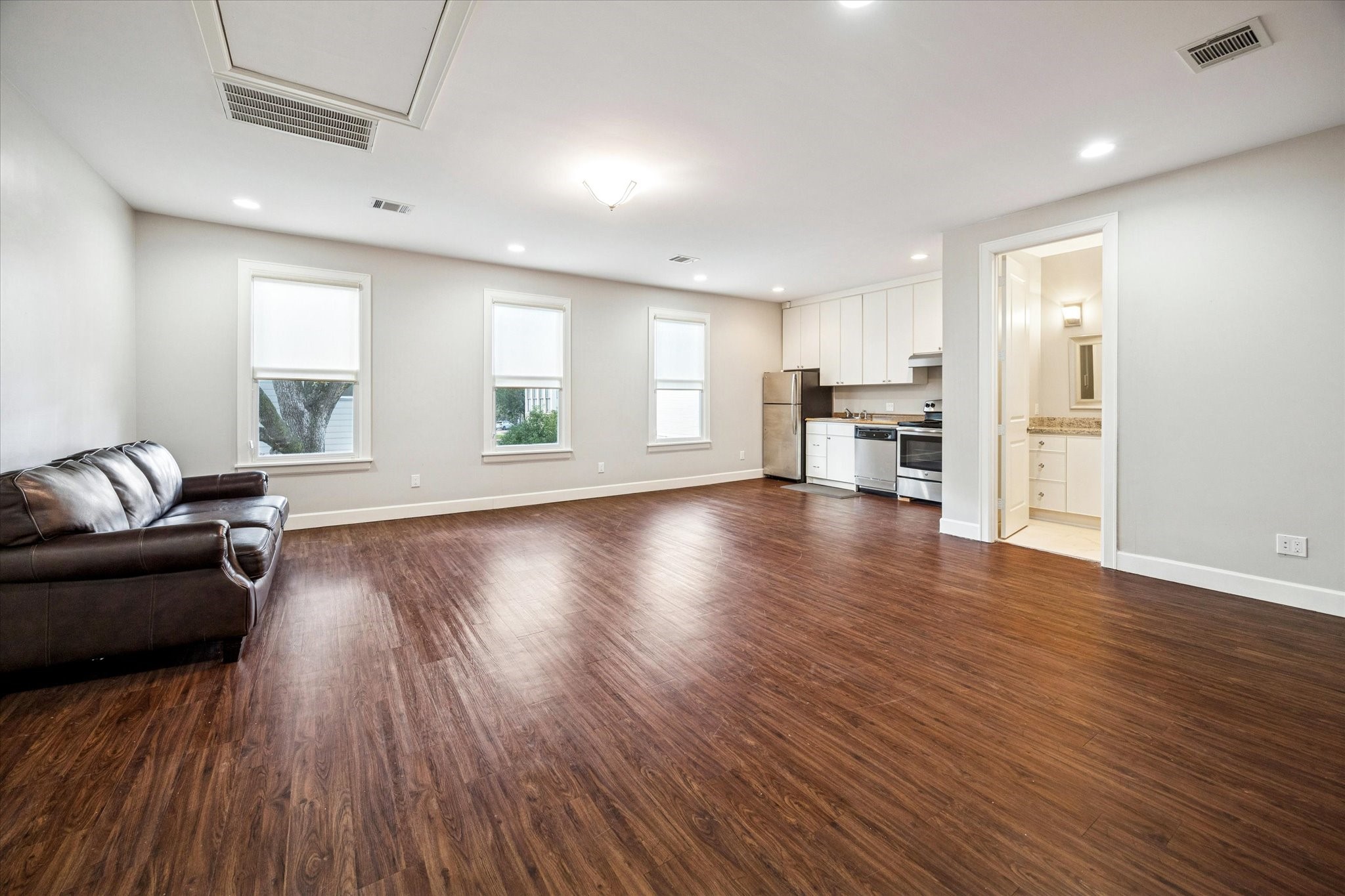 1226 Heights Boulevard Houston, TX 77008 - Photo 28 of 40 Spacious garage apartment includes kitchenette, hardwood-style flooring, and ample natural light. Perfect for guests, extended family, or home office use.