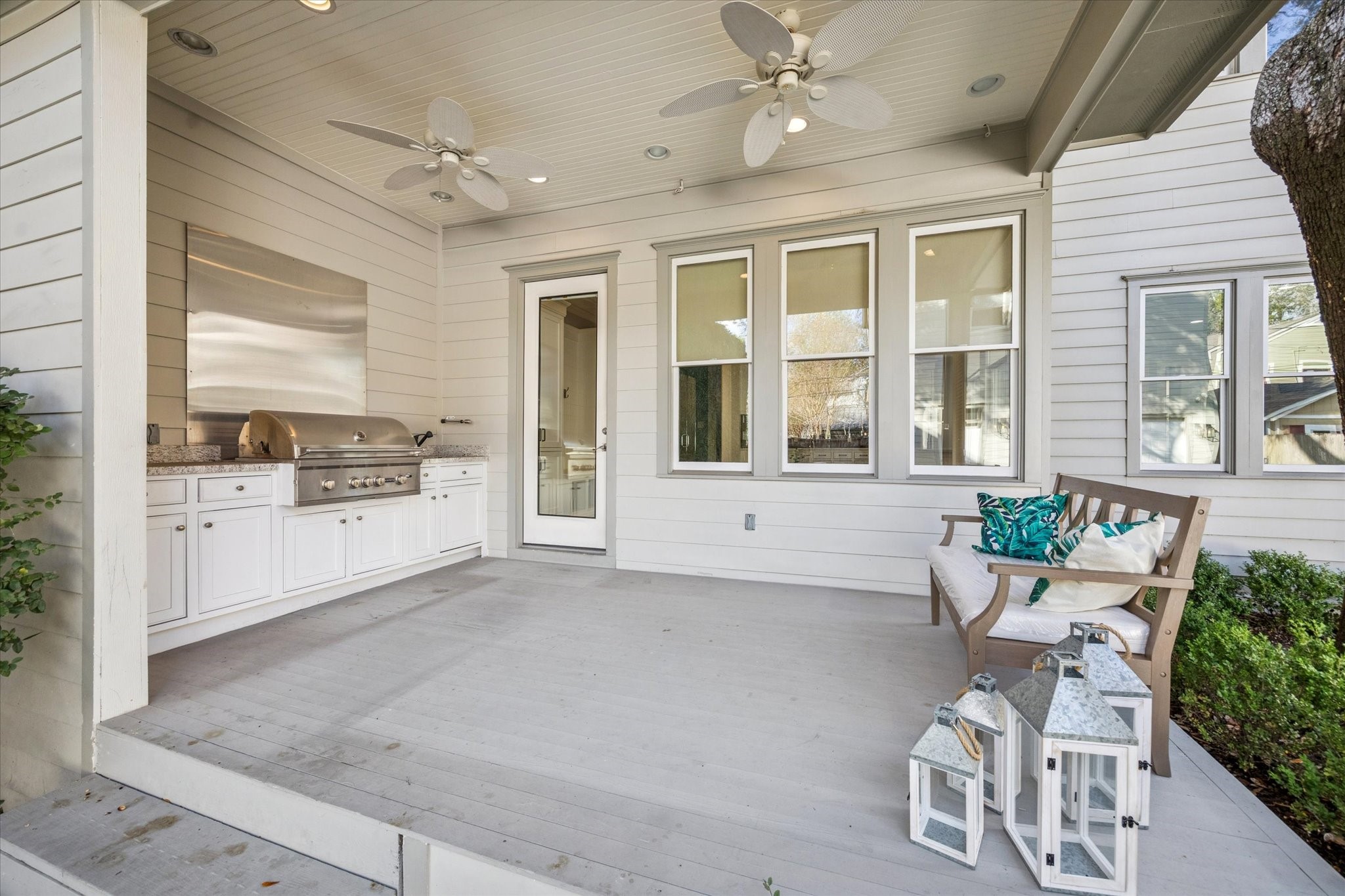 1226 Heights Boulevard Houston, TX 77008 - Photo 30 of 40 Covered patio features an outdoor kitchen, ceiling fans, and ample space for seating and entertaining. A seamless extension of indoor living, ideal for year-round enjoyment.