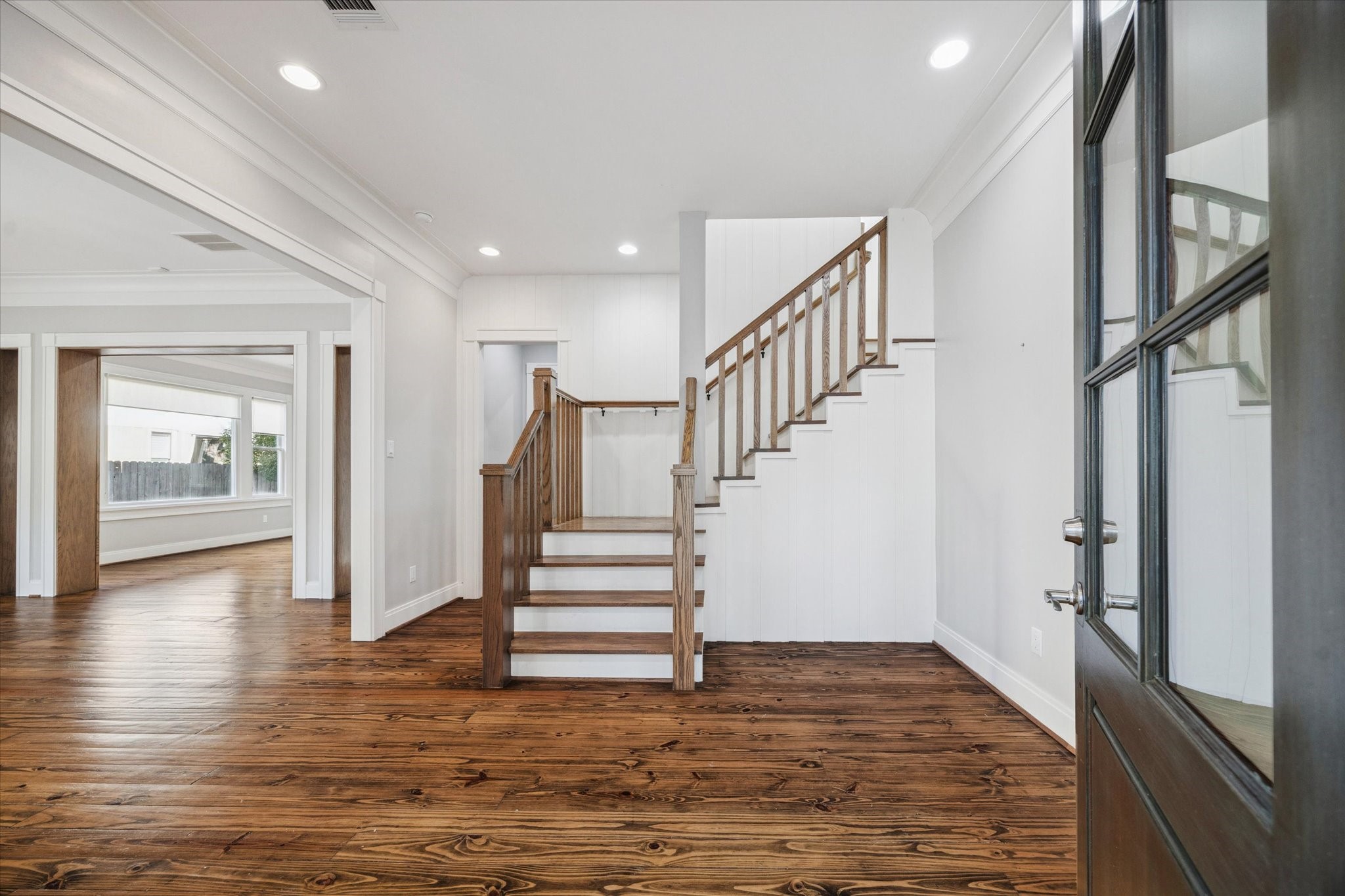 1226 Heights Boulevard Houston, TX 77008 - Photo 4 of 40 Bright entry showcases rich hardwood floors and a beautifully crafted staircase. Thoughtful architectural details set the tone for the rest of the home.