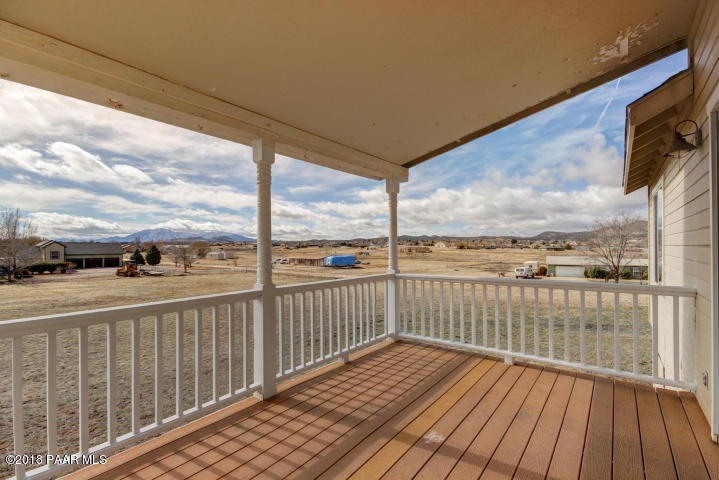 2165 West Lazy Ranch Road Chino Valley, AZ 86323 - Photo 14 of 17 a view of a balcony with wooden floor next to a yard