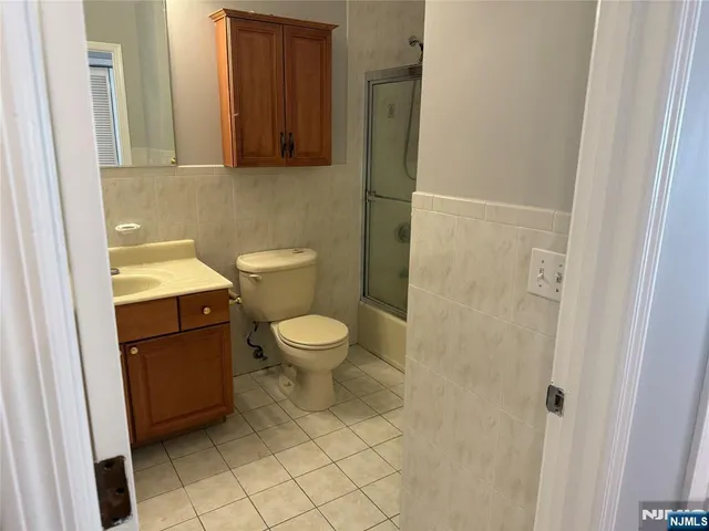 a white toilet sitting next to a bathroom sink