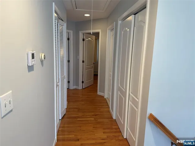 a view of a hallway with a wooden door