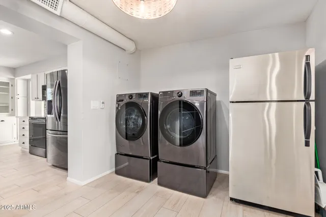 a white refrigerator freezer and a stove sitting inside of a kitchen