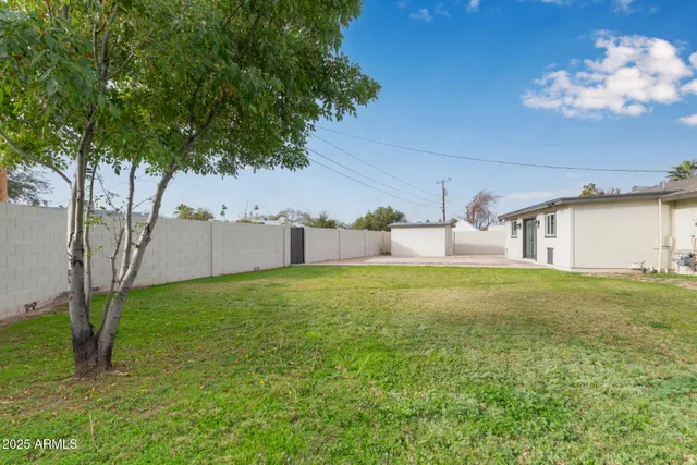 a backyard of a house with table and chairs