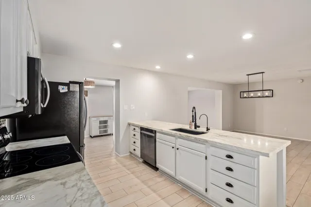 a kitchen with a sink and cabinets