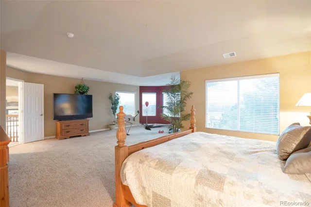 a bed room with a bed and a flat screen tv