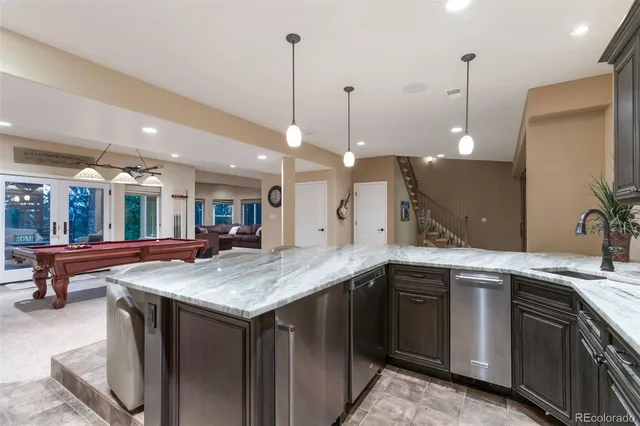 a kitchen with a sink and a wooden floor