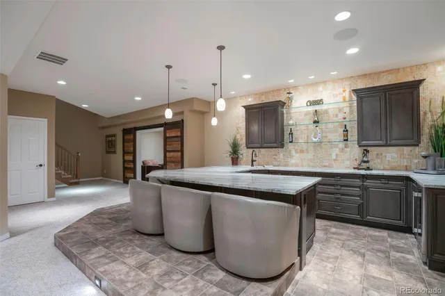 a kitchen with kitchen island a sink stainless steel appliances and cabinets