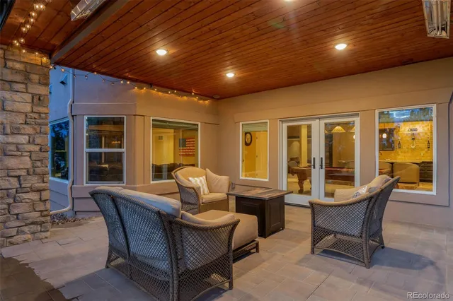 a dining room with furniture and large windows