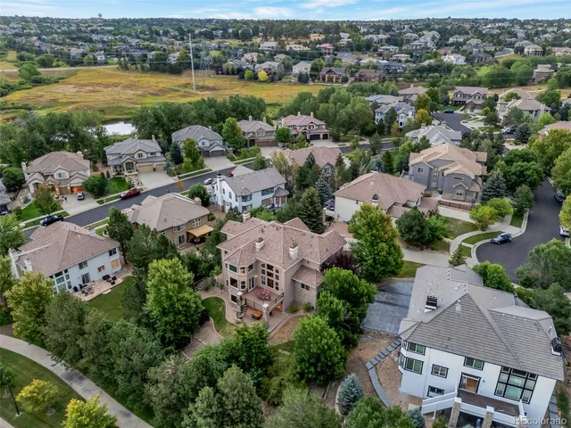 an aerial view of residential houses with outdoor space and river