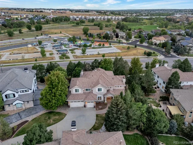 an aerial view of a house with yard and lake view