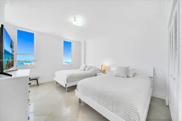 a bedroom with two beds and a couch