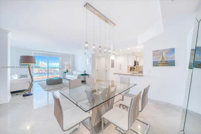 a view of a dining room with furniture and a chandelier