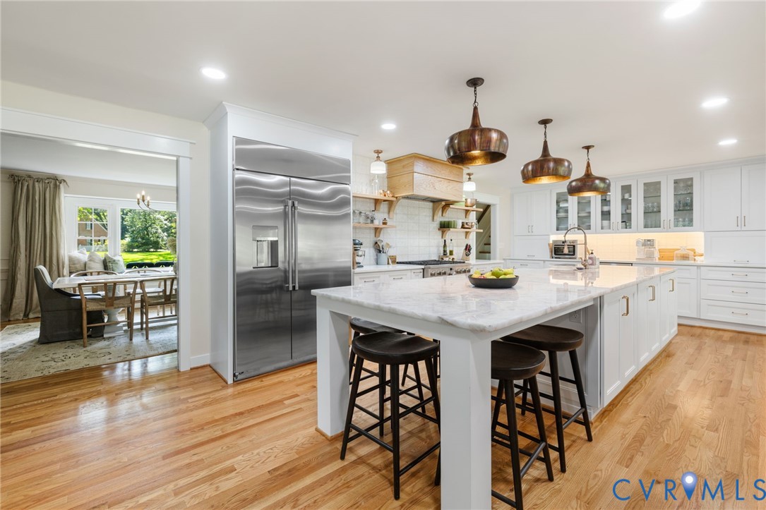 2360 Castlebridge Road Midlothian, VA 23113 - Photo 11 of 50 a kitchen with stainless steel appliances granite countertop a kitchen island a stove and a wooden floor