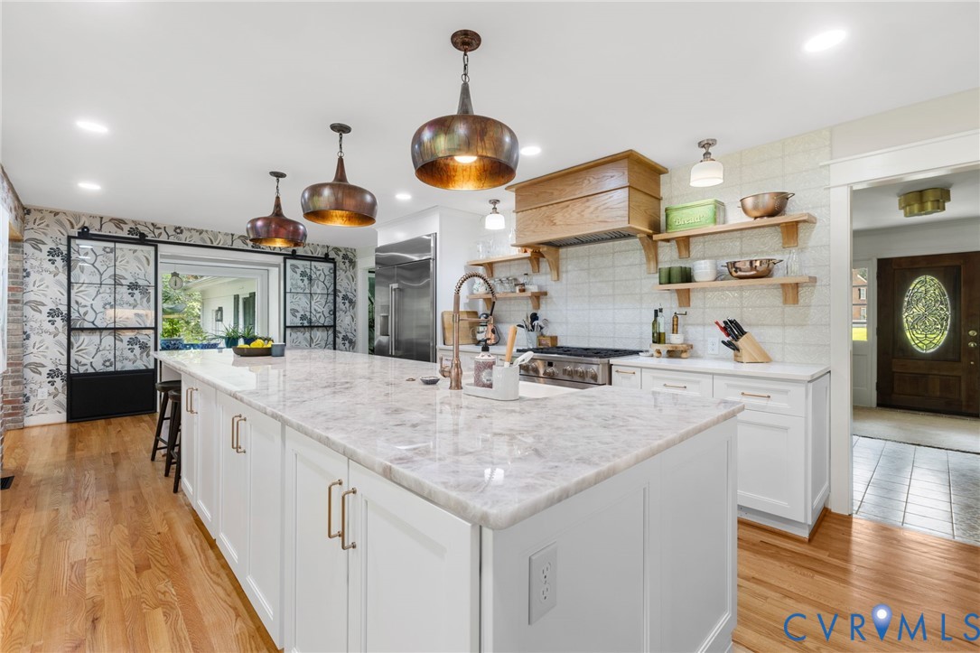 2360 Castlebridge Road Midlothian, VA 23113 - Photo 15 of 50 a kitchen with stainless steel appliances granite countertop a sink a stove and a wooden floors
