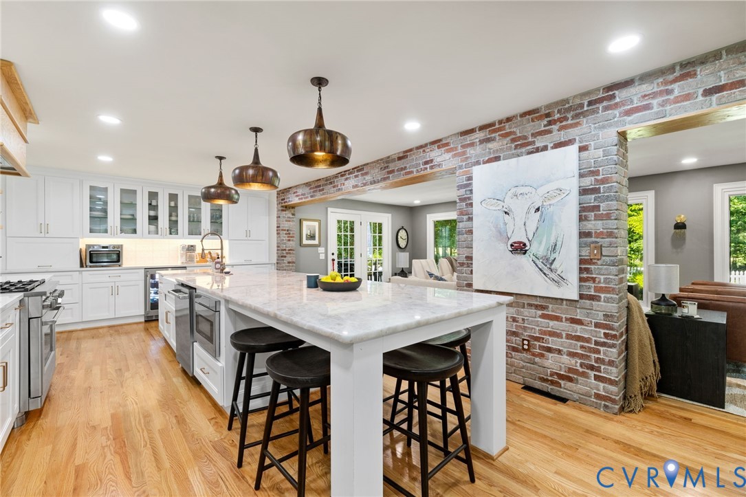 2360 Castlebridge Road Midlothian, VA 23113 - Photo 10 of 50 a kitchen with stainless steel appliances kitchen island granite countertop a table chairs sink and cabinets