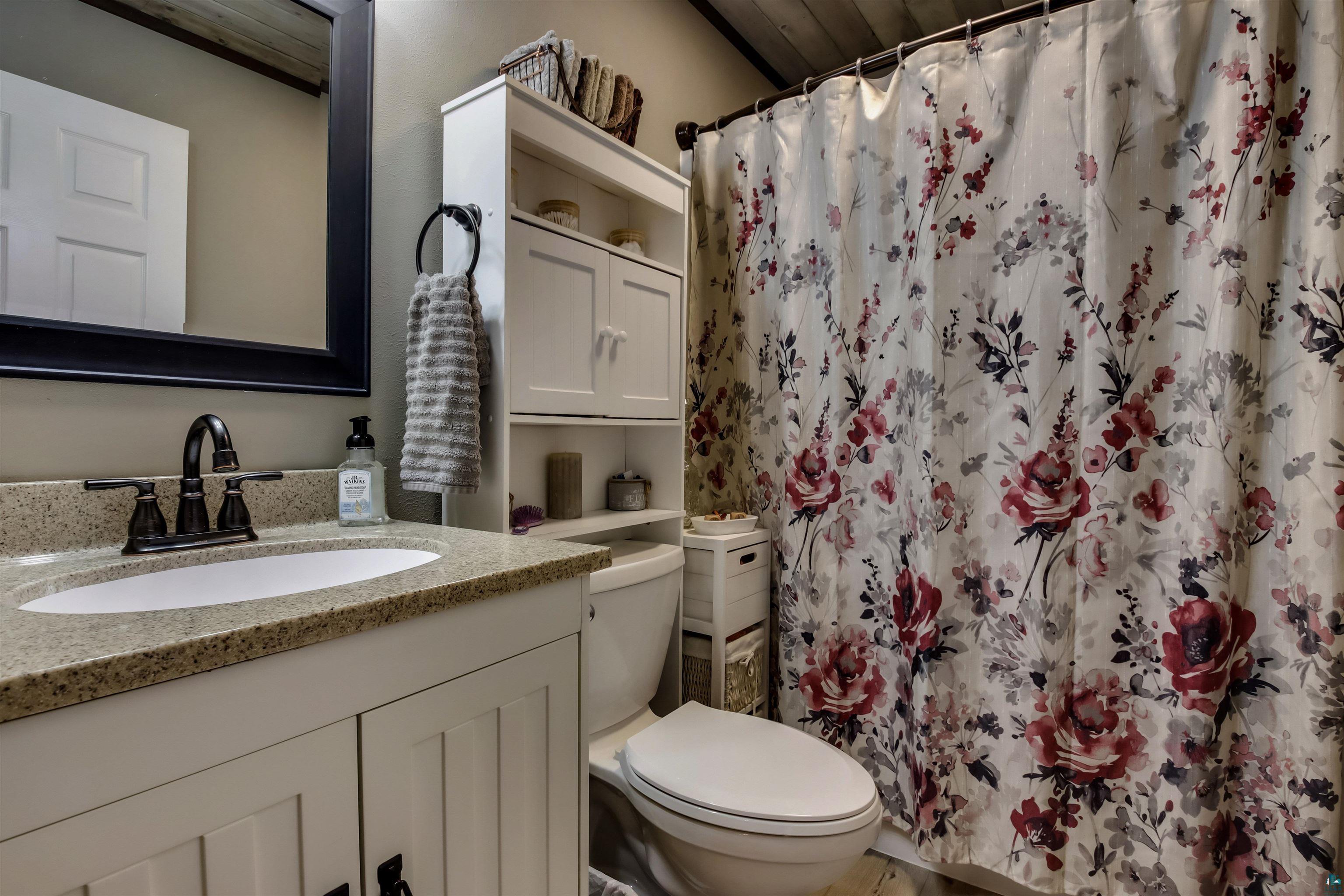 N3685 Fenander Road Spooner, WI 54801 - Photo 32 of 38 Bathroom featuring vanity, toilet, and walk in shower