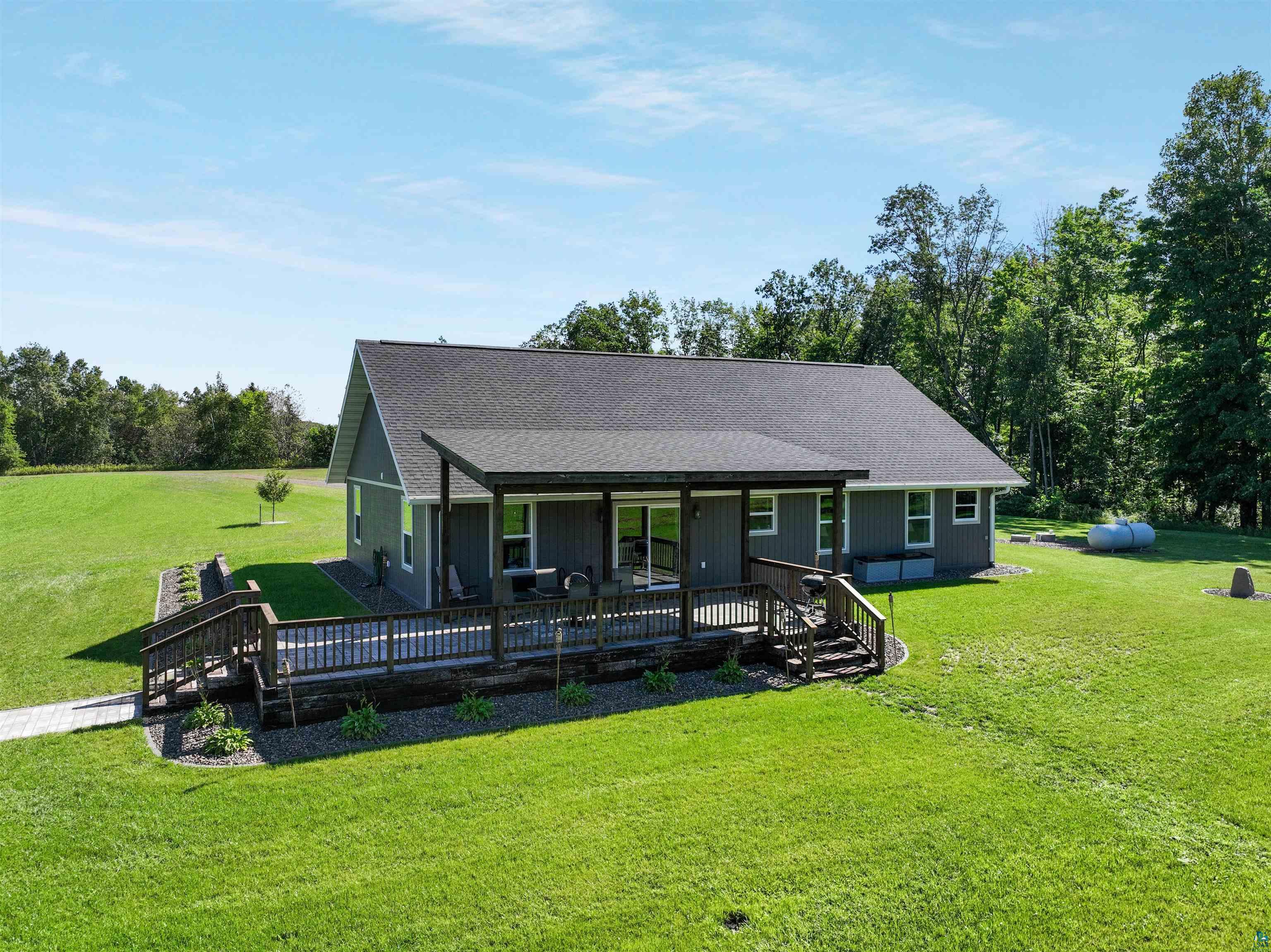 N3685 Fenander Road Spooner, WI 54801 - Photo 5 of 38 Ranch-style home with a wooden deck and a front yard