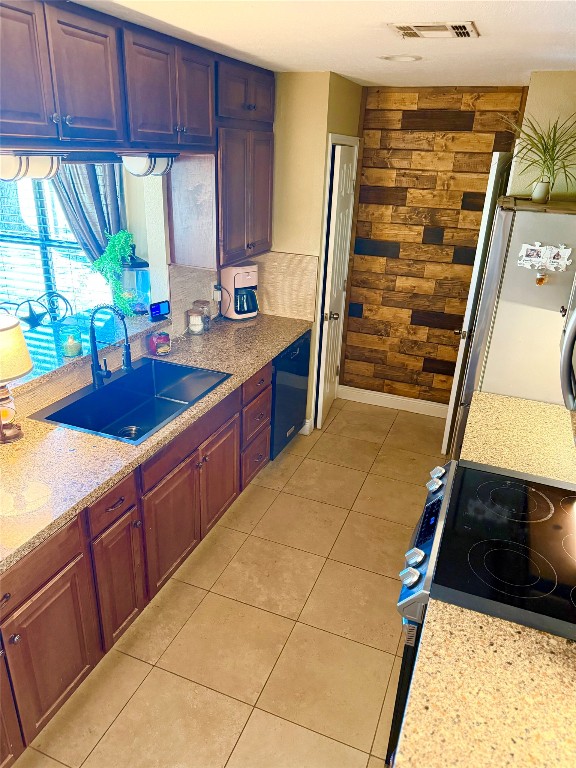 211 Rabbit Hollow Lane Georgetown, TX 78626 - Photo 11 of 32 Kitchen featuring range with electric cooktop, freestanding refrigerator, TWO pantries, light tile patterned floors, and black dishwasher