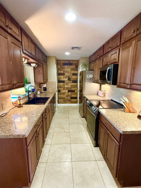 211 Rabbit Hollow Lane Georgetown, TX 78626 - Photo 18 of 34 a large kitchen with kitchen island granite countertop a large counter top and sink