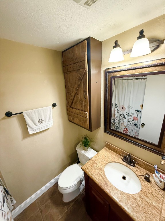 211 Rabbit Hollow Lane Georgetown, TX 78626 - Photo 22 of 32 Full bath featuring curtained shower, a textured ceiling, vanity, and dark tile patterned flooring