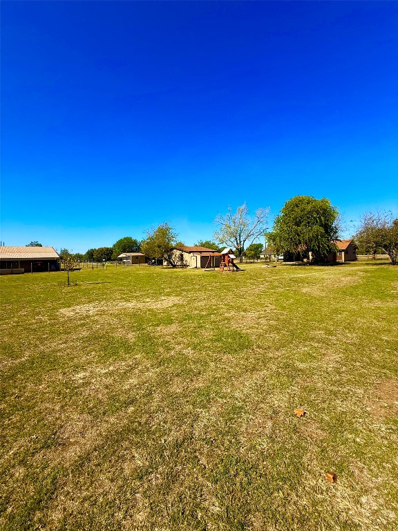 211 Rabbit Hollow Lane Georgetown, TX 78626 - Photo 25 of 32 View of green lawn featuring a rural view on fenced back yard