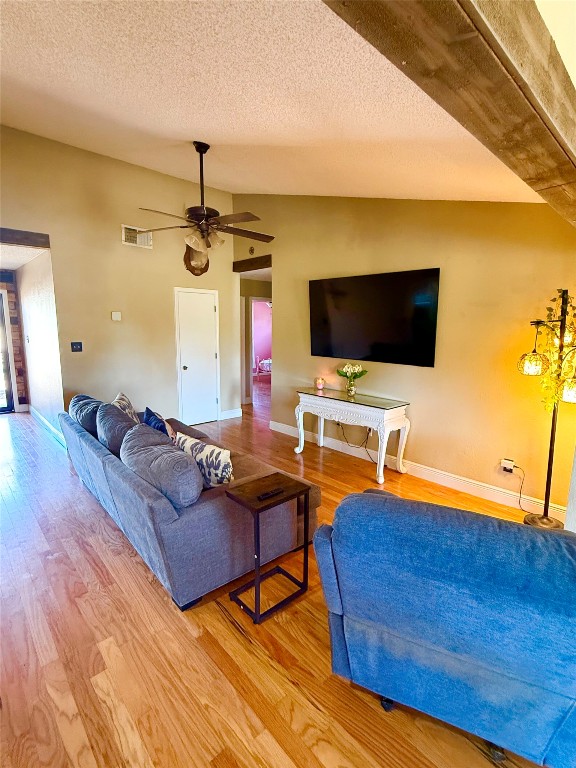 211 Rabbit Hollow Lane Georgetown, TX 78626 - Photo 5 of 32 Living room with vaulted ceiling, wood finished floors, a textured ceiling, and a ceiling fan
