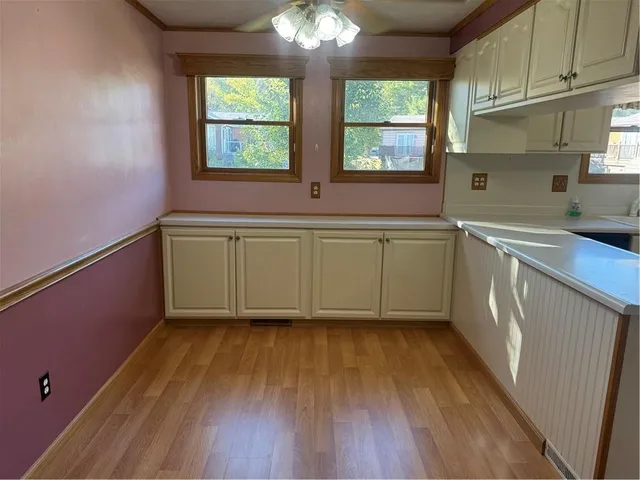 a kitchen with a refrigerator sink and cabinets