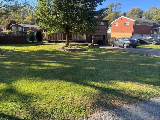 a swimming pool with outdoor seating and yard