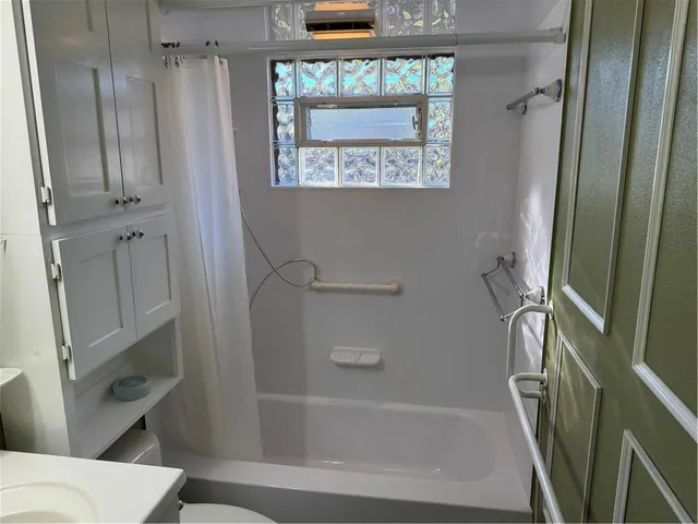 a bathroom with a bathtub and a shower